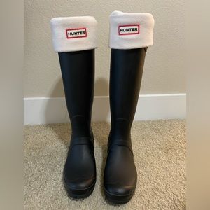 Matte black tall Hunter rain boots with cream socks